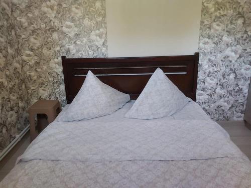 a bed with white sheets and pillows on it at Luxury building in Abovyan in Elar
