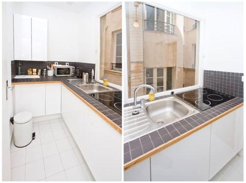 a kitchen with white cabinets and a sink at Paris Les Halles in Paris