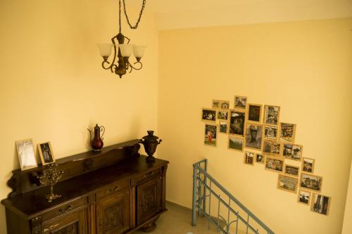 a room with a dresser and pictures on the wall at The Rolé House in Gurjaani
