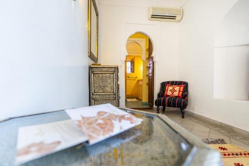 a glass table with a plate of food in a room at Riad El Youssoufi in Marrakech
