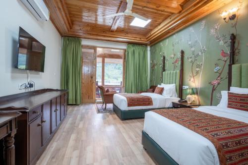 a hotel room with two beds and a sink at Ezzenza Swarg by Beas Golf Resort - Devlok Manali in Baragrān