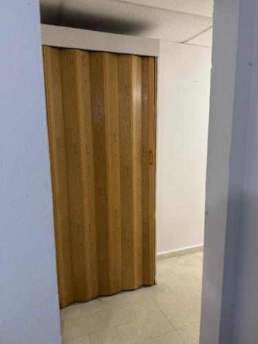 a wooden door in an empty room at Economic Studio in Santurce Area, Up to 4 guests in San Juan