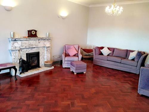a living room with a couch and a fireplace at Annalee House, Knappagh Valley - 1 hour to Airport in Shercock