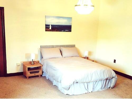 a bedroom with a bed and a table with two lamps at Annalee House, Knappagh Valley - 1 hour to Airport in Shercock