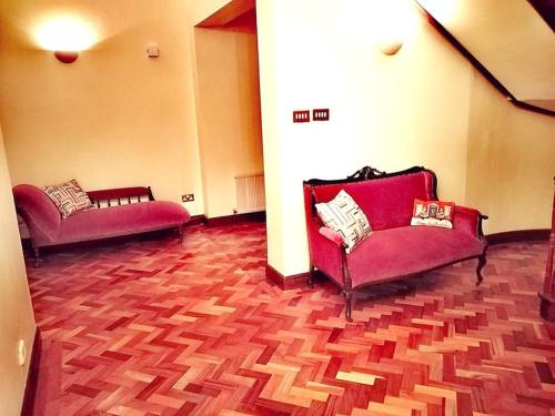 two red couches in a room with wooden floors at Annalee House, Knappagh Valley - 1 hour to Airport in Shercock