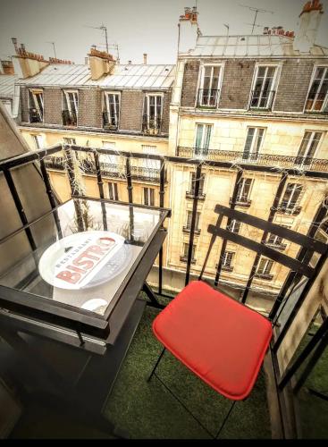 un fauteuil rouge installé au-dessus du balcon dans l'établissement SINGLE STUDIO QuartierLatin, à Paris