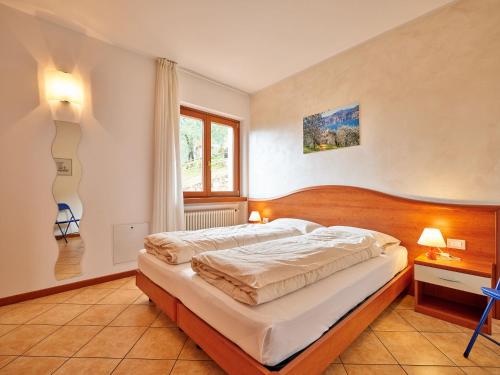 a bedroom with a large bed and a window at Appartamenti La Perla in Malcesine
