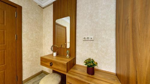 a bathroom with a wooden vanity and a mirror at Denis suit apart in Istanbul