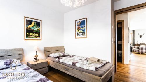 a bedroom with two beds in a room at Haus Golmenegg, Riederalp in Riederalp