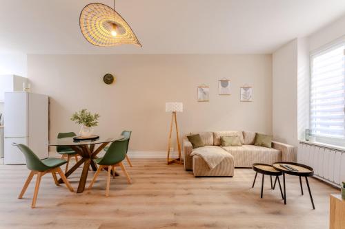 un salon avec un canapé, une table et des chaises dans l'établissement Maison à Roubaix, à Roubaix