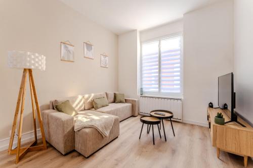 un salon avec un canapé et une télévision dans l'établissement Maison à Roubaix, à Roubaix