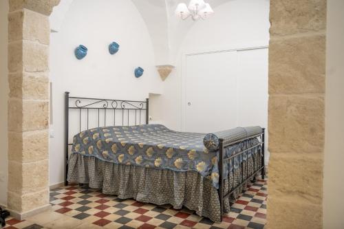 a bedroom with a bed and a checkered floor at Mille Lire - Family suites in Monopoli