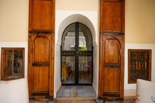 an entrance to a building with wooden doors at Riad El Youssoufi in Marrakech