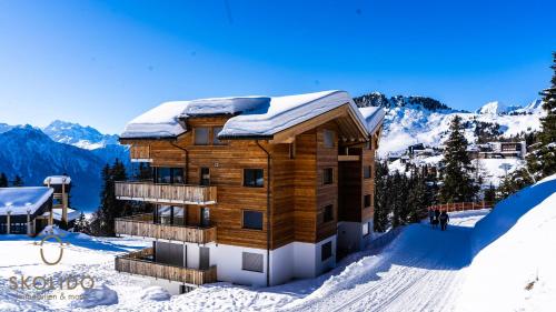 a wooden building in the snow with snow at Haus Golmenegg, Riederalp in Riederalp