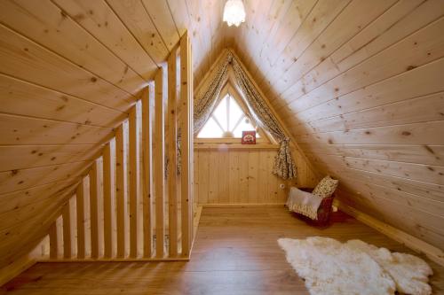 a room in a log cabin with a window at Marusina Chalets in Szaflary