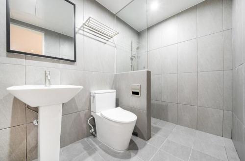 a bathroom with a white toilet and a sink at H Avenue Hotel Chungjangro in Gwangju
