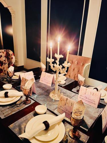a table with a cross and candles on it at Victorian Elegance Luxury Stays in Amritsar