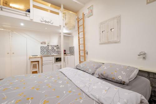 une petite chambre avec un lit et une cuisine dans l'établissement Superb tiny house in heart of Paris 1st!, à Paris