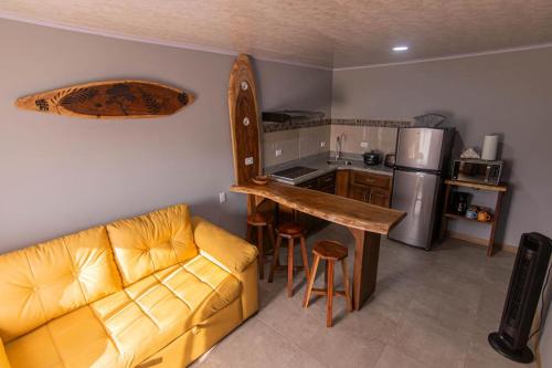 a living room with a couch and a kitchen at 1968house in Monteverde Costa Rica