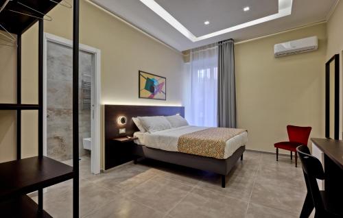 a bedroom with a bed and a desk and a chair at Palm Suites in Naples