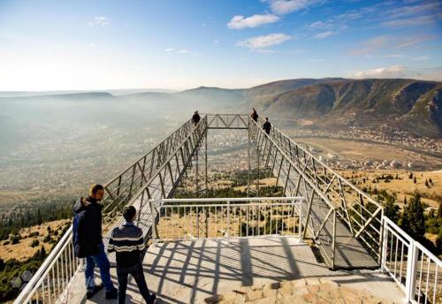 a group of people standing on top of a viewing bridge at Adria centar Koćuša in Ljubuški