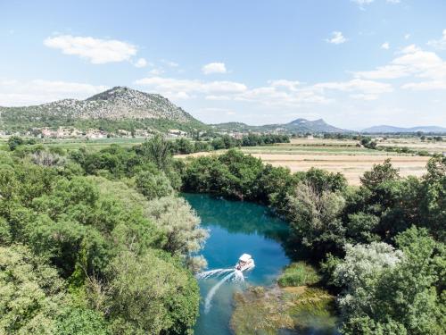 an aerial view of a river with a waterfall at Adria centar Koćuša in Ljubuški