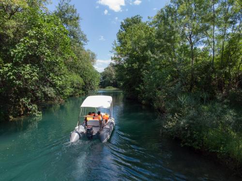 a boat in the water on a river at Adria centar Koćuša in Ljubuški