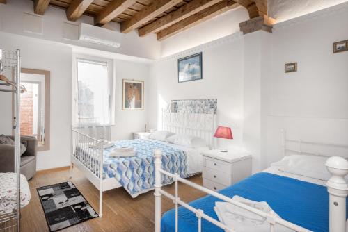 a bedroom with a bed with a blue blanket at Arcadia in Verona