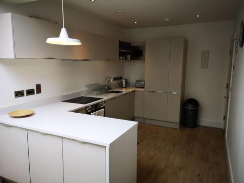 a kitchen with white cabinets and a white counter top at Home in Blackrock Dublin in Dublin