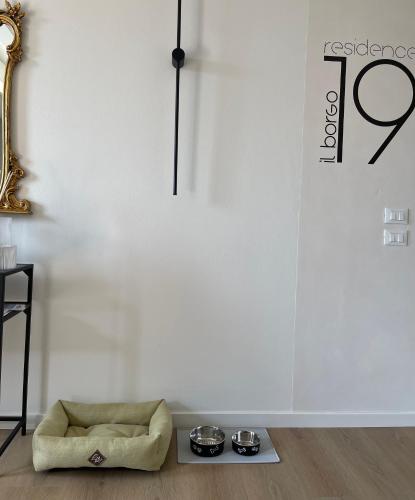 a white room with a dog sitting on the floor at Residence19ilborgo in Asolo