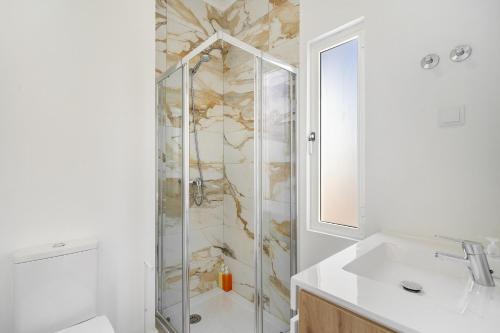 a bathroom with a shower and a sink at Modern Nomad Hub Stylish Spaces for Remote Living in Lisbon
