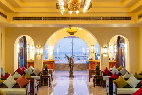 a lobby with chairs and a chandelier at Faraana Heights Aqua Park in Sharm El Sheikh