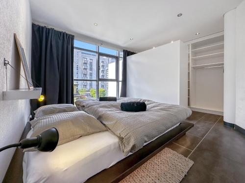 a bedroom with a bed and a large window at Dolce Vita close to 4 Vallées - Swiss Alps in Martigny-Ville