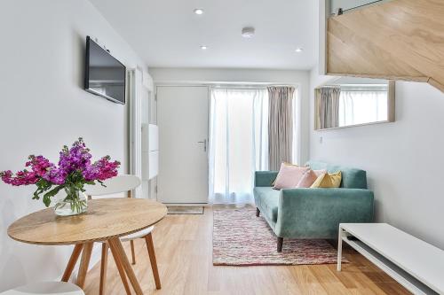 a living room with a couch and a table at 1BR Gem in Great Location With Parking in Sheffield