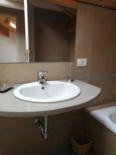 a white sink in a bathroom with a mirror at Az. Agr. IL PARADISO di Beatrice Bondielli in Pontremoli