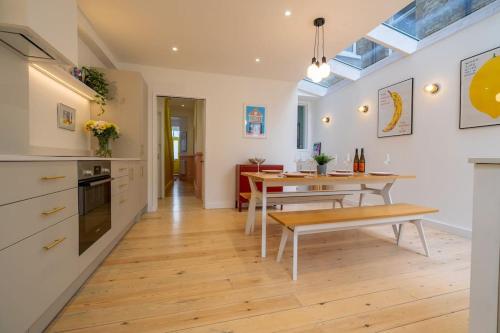 a kitchen with a table and a dining room at Stunning Broadstairs 5 bed Family Hse, Parking, Garden in Kent