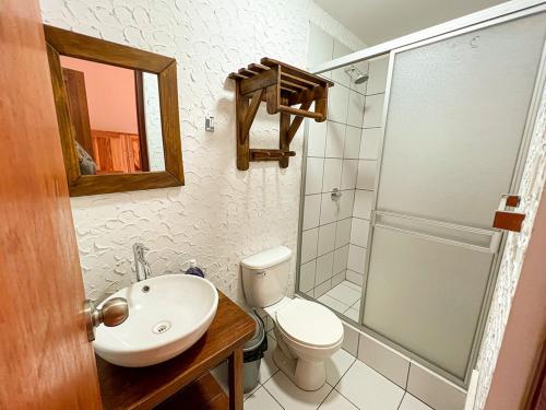 a bathroom with a sink and a toilet and a shower at Tupac Huaraz in Huaraz