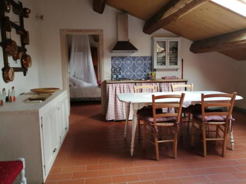 a kitchen with a table and chairs in a room at Az. Agr. IL PARADISO di Beatrice Bondielli in Pontremoli