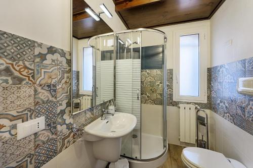 a bathroom with a sink and a toilet and a mirror at Tenuta Dorata in Ragusa