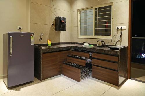 a kitchen with a refrigerator and a counter top at 'Sumadhu Homes 301 ' in Kolhapur