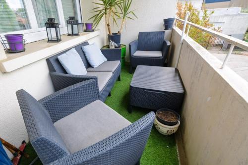 a balcony with two chairs and a table and chairs at T4 Spacieux , Découvrez le calme du Petit Charran in Valence