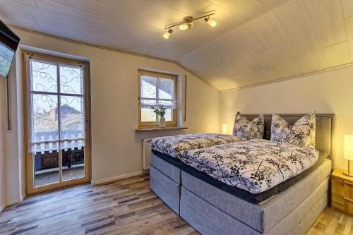 a bedroom with a large bed and a window at Landhaus Melch in Zwiesel