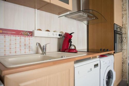 une cuisine avec un évier et une machine à laver dans l'établissement appartement 2 chambre, climatisation, plage à 50m, à Palavas-les-Flots