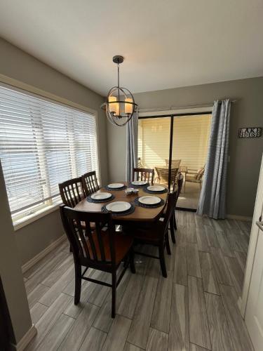 a dining room with a wooden table and chairs at Serenity Oaks at The Getaways in Kimberling City
