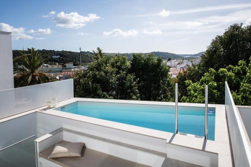 a swimming pool on the roof of a house at Casa Nova in Silves