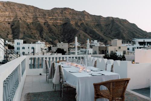 a table on a balcony with a view of a mountain at Salaam Space in Muscat