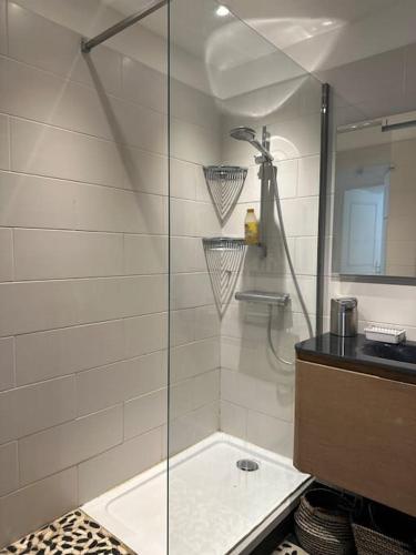 une douche avec une porte vitrée dans une salle de bain dans l'établissement ® Le Breteuil - Superbe T2 - Plein centre, à Marseille