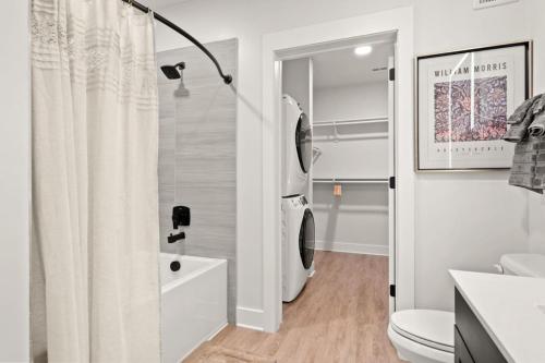 a bathroom with a shower curtain and a toilet at Luxurious Urban Retreat with Amazing Amenities in Tampa