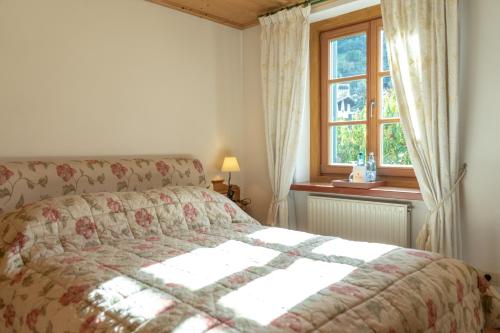 a bedroom with a bed in front of a window at Schlosswirt Forst in Lagundo