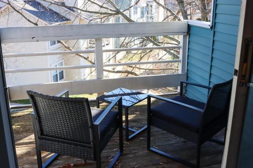 two chairs and a table on a porch at Luxury Apartment in Virginia Beach